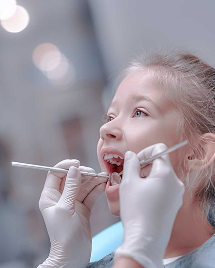 Child getting their teeth examined