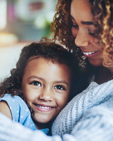 Mother and daughter smiling