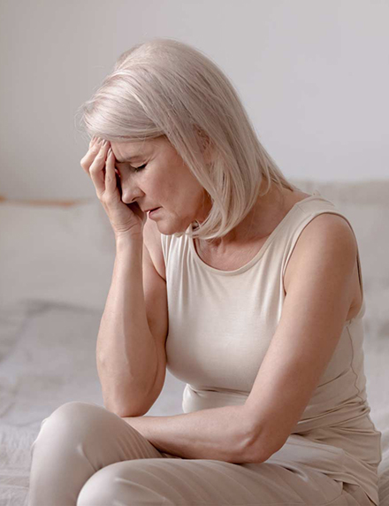 Woman holding head in pain