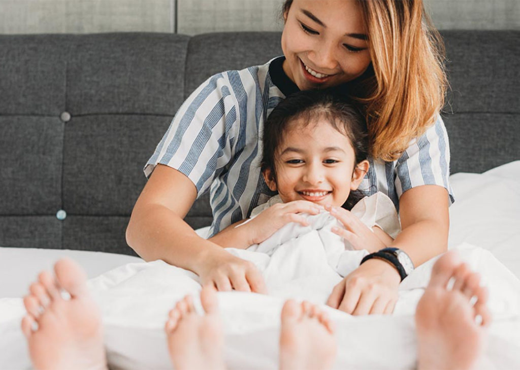 Mother and child on bed