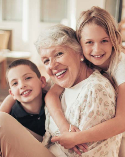 Grandmother with two grandchildren smiling