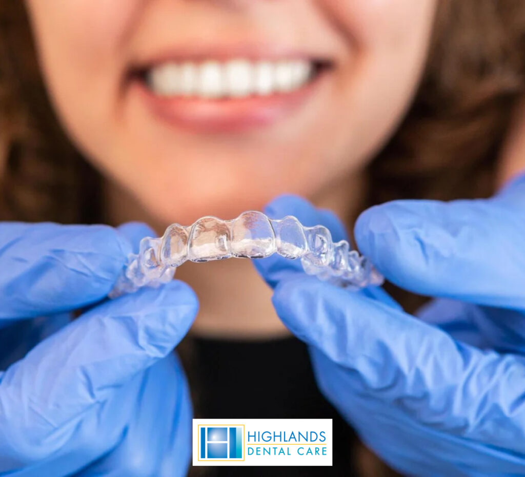 Close-up of clear Invisalign braces placed on a set of teeth, demonstrating orthodontic treatment.